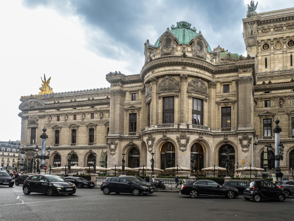 Beautiful architectural detail of the Palais Garnier in Paris on a cloudy day.