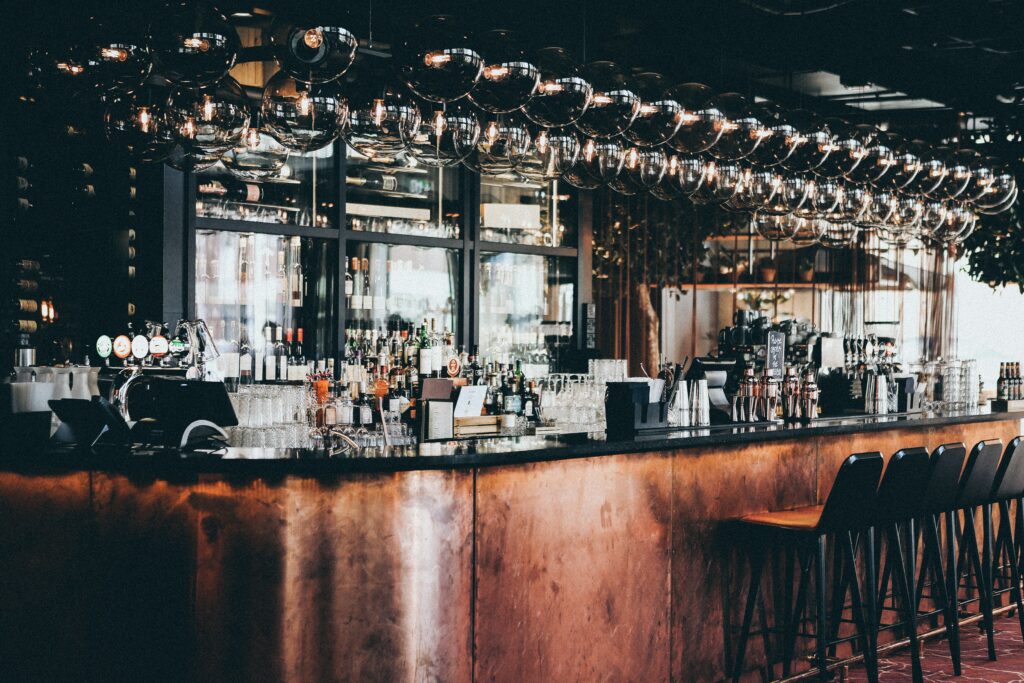 wide shot of bottles and glasses in display cabinet at a bar in scandic hotel in copenhagen, denmark